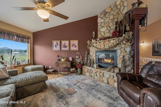 222 E Remington Rd, Athol, ID 83801 - living area with vaulted ceiling, a stone fireplace, a ceiling fan, and wood finished floors