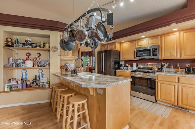 222 E Remington Rd, Athol, ID 83801 - kitchen with appliances with stainless steel finishes, a sink, light wood-type flooring, and light brown cabinetry