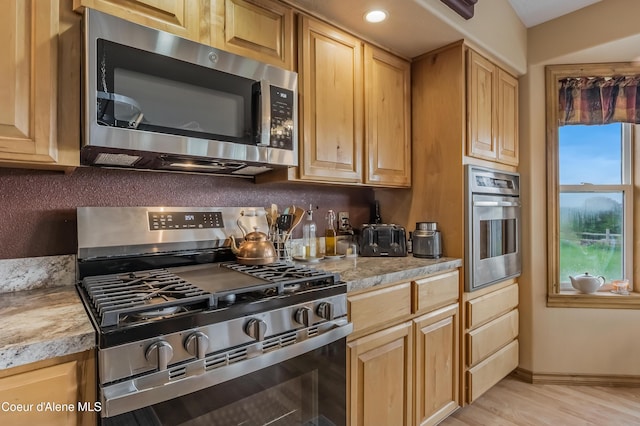 222 E Remington Rd, Athol, ID 83801 - kitchen with appliances with stainless steel finishes, light countertops, baseboards, light wood finished floors, and light brown cabinetry