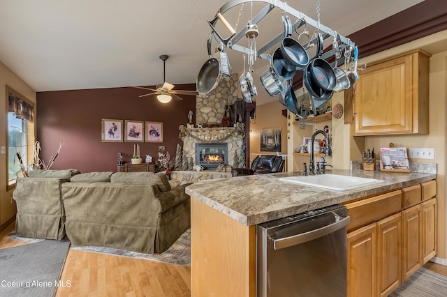 222 E Remington Rd, Athol, ID 83801 - kitchen featuring dishwasher, a sink, a ceiling fan, light wood-type flooring, and a fireplace