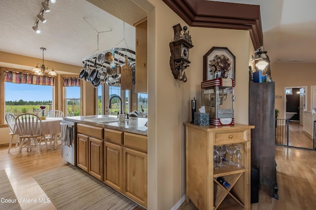 222 E Remington Rd, Athol, ID 83801 - kitchen featuring a sink, light wood-style floors, stainless steel dishwasher, a chandelier, and hanging light fixtures