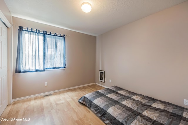 222 E Remington Rd, Athol, ID 83801 - bedroom featuring wood finished floors, baseboards, and a closet