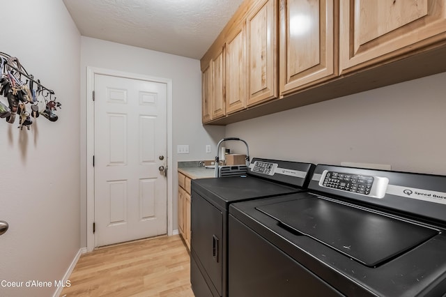 222 E Remington Rd, Athol, ID 83801 - laundry room with washer and dryer, cabinet space, light wood-style floors, a textured ceiling, and baseboards