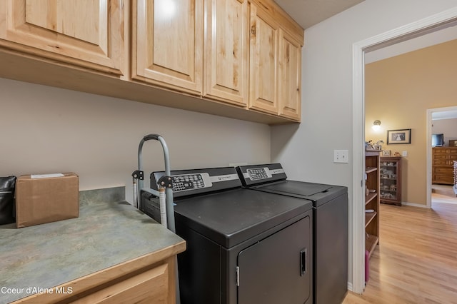 222 E Remington Rd, Athol, ID 83801 - laundry room with cabinet space, washer and dryer, light wood finished floors, and baseboards