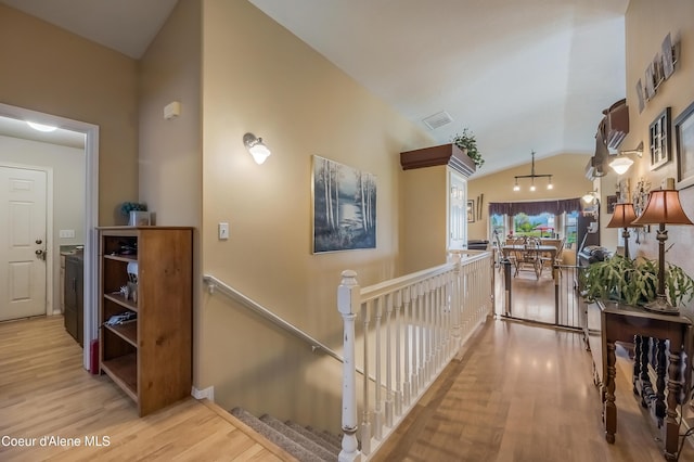 222 E Remington Rd, Athol, ID 83801 - hallway with light wood-style flooring, vaulted ceiling, and an upstairs landing