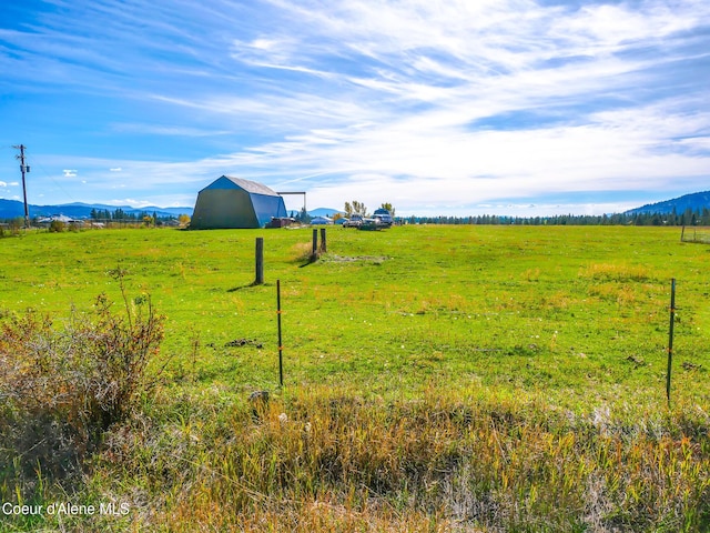222 E Remington Rd, Athol, ID 83801 - view of yard with a barn, a view of countryside, an outdoor structure, and a mountain view