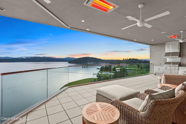 2051 S Island Green Dr, Coeur Dalene, ID 83814 - balcony at dusk featuring ceiling fan and a water and mountain view