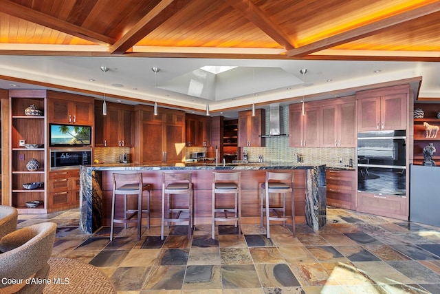 2051 S Island Green Dr, Coeur Dalene, ID 83814 - kitchen featuring reddish brown cabinets, wall chimney range hood, wood ceiling with exposed beams, tasteful backsplash, and stone finish floors