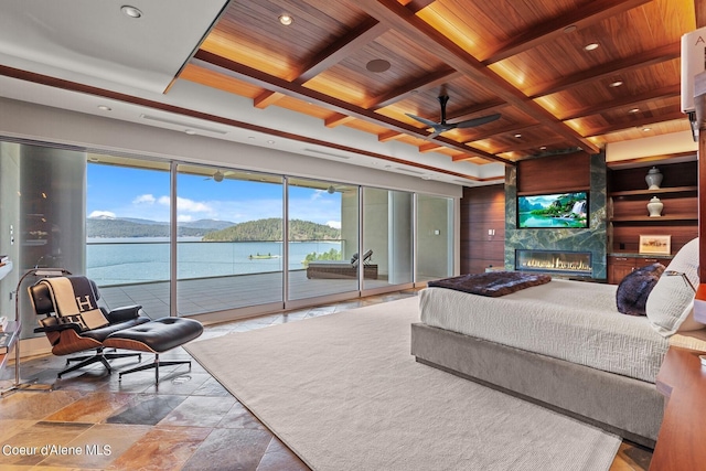 2051 S Island Green Dr, Coeur Dalene, ID 83814 - bedroom featuring wooden ceiling with exposed beams, coffered ceiling, access to outside, a large fireplace, and stone finish flooring