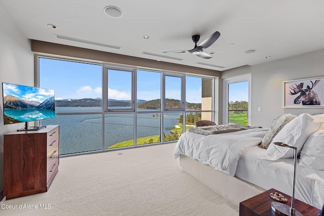 2051 S Island Green Dr, Coeur Dalene, ID 83814 - bedroom with a water view, light colored carpet, access to exterior, ceiling fan, and recessed lighting