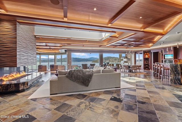 2051 S Island Green Dr, Coeur Dalene, ID 83814 - living room featuring a multi sided fireplace, stone tile floors, and wooden ceiling