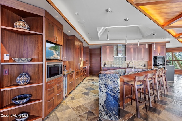 2051 S Island Green Dr, Coeur Dalene, ID 83814 - kitchen featuring stainless steel microwave, a tray ceiling, dark stone counters, a sink, and beverage cooler