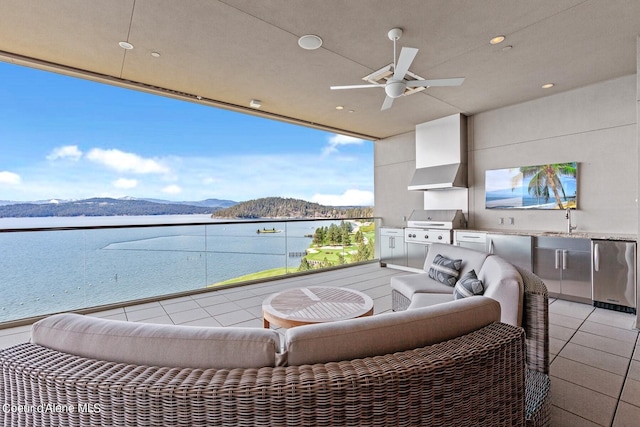 2051 S Island Green Dr, Coeur Dalene, ID 83814 - view of patio / terrace with a water and mountain view, a ceiling fan, a sink, and outdoor lounge area