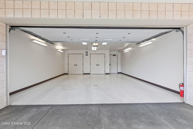 2051 S Island Green Dr, Coeur Dalene, ID 83814 - garage with baseboards and a garage door opener