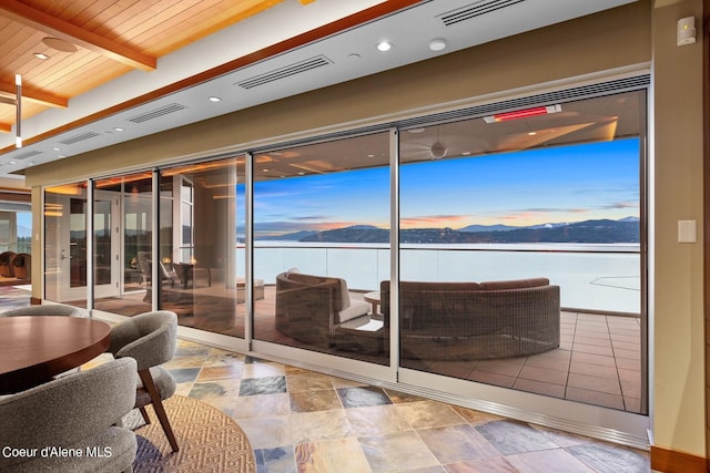 2051 S Island Green Dr, Coeur Dalene, ID 83814 - interior space with stone finish flooring, a mountain view, wooden ceiling with exposed beams, plenty of natural light, and recessed lighting