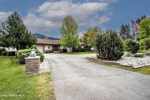 6264 N 15th St, Dalton Gardens, ID 83815 - ranch-style house with asphalt driveway, a garage, a front yard, and a chimney
