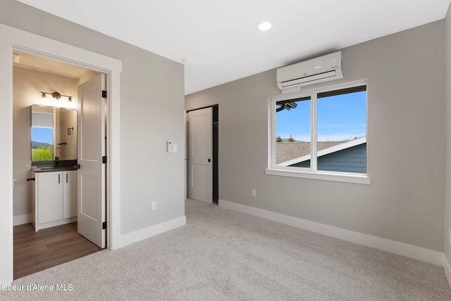 1670 Onyx Ct, Sandpoint, ID 83864 - unfurnished bedroom with an AC wall unit, carpet floors, multiple windows, baseboards, and recessed lighting