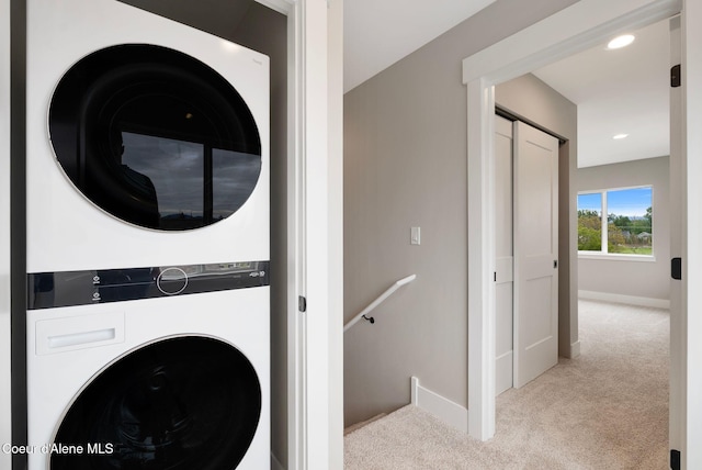 1670 Onyx Ct, Sandpoint, ID 83864 - laundry area featuring stacked washer / dryer, carpet flooring, baseboards, and recessed lighting