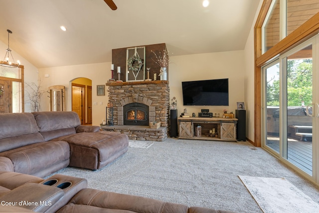 17378 N Freddi Rd, Rathdrum, ID 83858 - living area with arched walkways, carpet, vaulted ceiling, a fireplace, and a ceiling fan