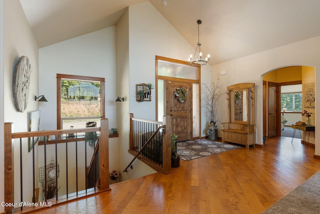 17378 N Freddi Rd, Rathdrum, ID 83858 - entryway with wood finished floors, arched walkways, a chandelier, and high vaulted ceiling
