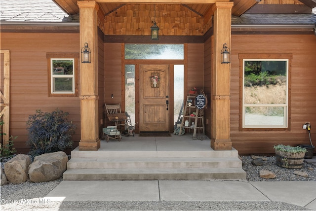 17378 N Freddi Rd, Rathdrum, ID 83858 - doorway to property featuring roof with shingles and a porch
