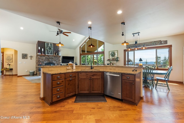17378 N Freddi Rd, Rathdrum, ID 83858 - kitchen with stainless steel dishwasher, a sink, healthy amount of natural light, a stone fireplace, and lofted ceiling