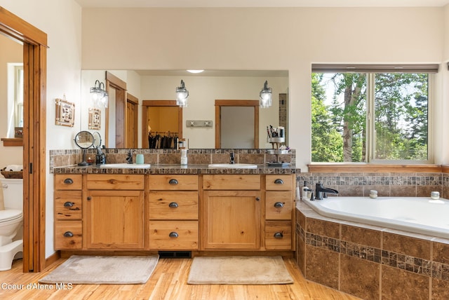 17378 N Freddi Rd, Rathdrum, ID 83858 - full bath with toilet, double vanity, a bath, and wood finished floors