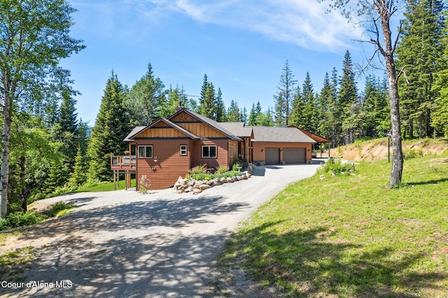 17378 N Freddi Rd, Rathdrum, ID 83858 - chalet / cabin with a garage, driveway, a front lawn, and a wooden deck