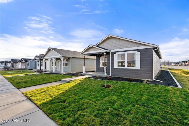 5082 E Norma Ave, Post Falls, ID 83854 - view of front facade with a front yard and a porch