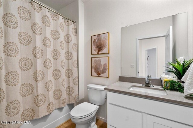 5082 E Norma Ave, Post Falls, ID 83854 - bathroom with vanity, toilet, and wood finished floors