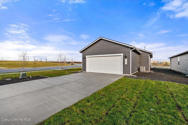 5082 E Norma Ave, Post Falls, ID 83854 - view of home's exterior featuring concrete driveway, a yard, and an attached garage