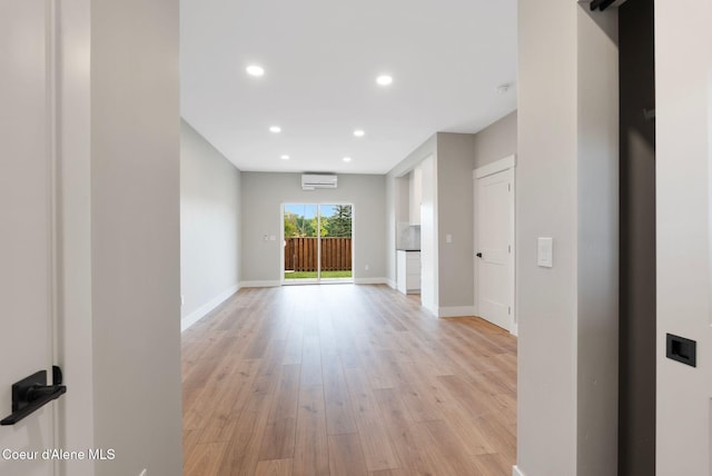 1674 Onyx Ct, Sandpoint, ID 83864 - empty room featuring a wall mounted air conditioner, light wood finished floors, baseboards, and recessed lighting