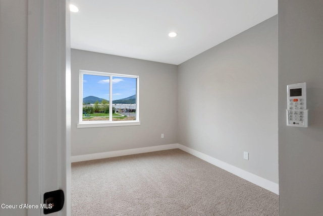 1674 Onyx Ct, Sandpoint, ID 83864 - carpeted empty room featuring baseboards, recessed lighting, and a mountain view