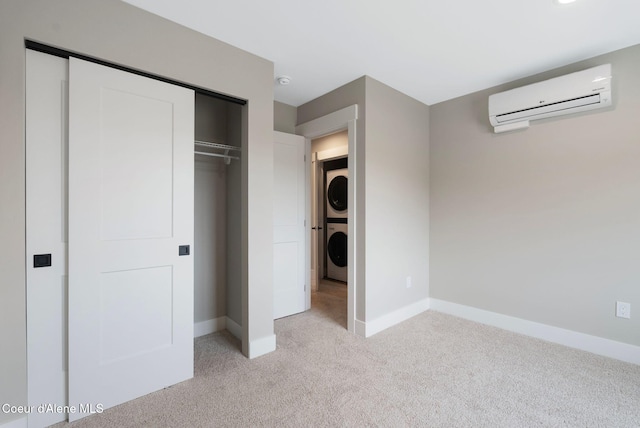 1674 Onyx Ct, Sandpoint, ID 83864 - unfurnished bedroom with stacked washer and clothes dryer, a wall unit AC, light colored carpet, and baseboards