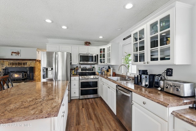 291 Comeback Bay Ln, Sagle, ID 83860 - kitchen with a sink, stainless steel appliances, a textured ceiling, white cabinetry, and glass insert cabinets