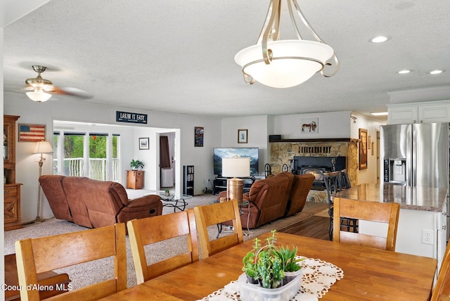 291 Comeback Bay Ln, Sagle, ID 83860 - dining area with a textured ceiling, a ceiling fan, a fireplace, and recessed lighting