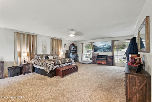 291 Comeback Bay Ln, Sagle, ID 83860 - carpeted bedroom with a glass covered fireplace and ceiling fan