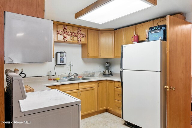 291 Comeback Bay Ln, Sagle, ID 83860 - kitchen featuring white appliances, a sink, and light countertops