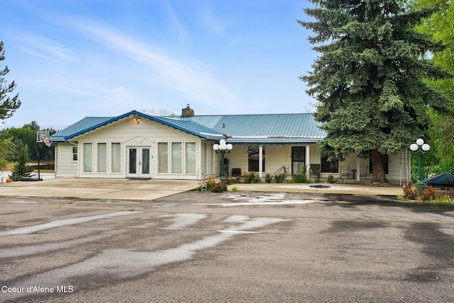 291 Comeback Bay Ln, Sagle, ID 83860 - view of front facade featuring a chimney, metal roof, and french doors