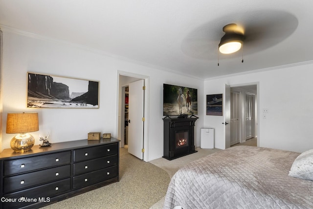 7104 W Kidd Island Rd, Coeur Dalene, ID 83814 - bedroom featuring ornamental molding, light carpet, a glass covered fireplace, and ceiling fan