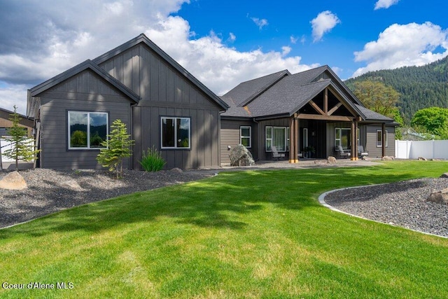 1831 E Dalton Ave, Dalton Gardens, ID 83815 - back of property featuring board and batten siding, a patio area, and a mountain view