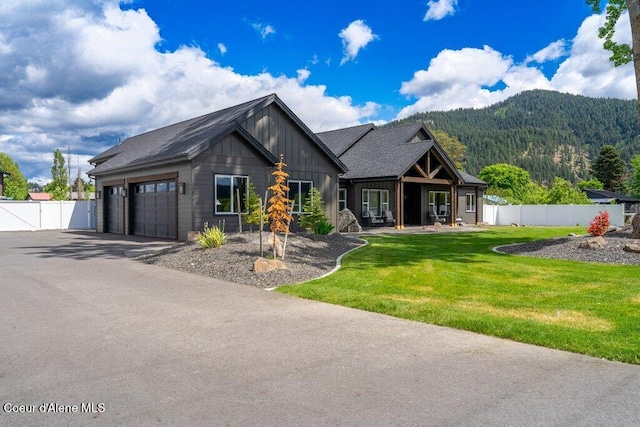 1831 E Dalton Ave, Dalton Gardens, ID 83815 - view of front of property featuring a mountain view, board and batten siding, a garage, and driveway