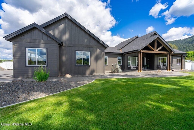 1831 E Dalton Ave, Dalton Gardens, ID 83815 - back of property featuring a lawn, board and batten siding, and a patio area