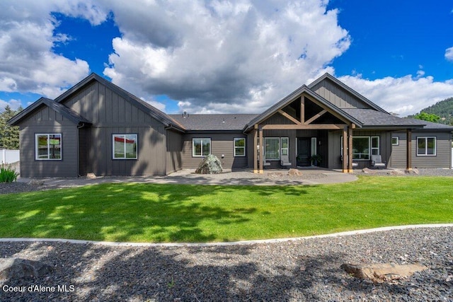 1831 E Dalton Ave, Dalton Gardens, ID 83815 - back of property featuring board and batten siding, a patio area, and a yard