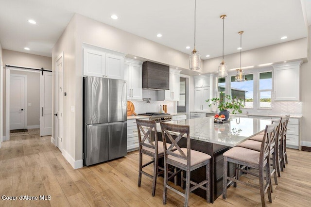 1831 E Dalton Ave, Dalton Gardens, ID 83815 - kitchen with freestanding refrigerator, decorative backsplash, white cabinetry, recessed lighting, and a barn door