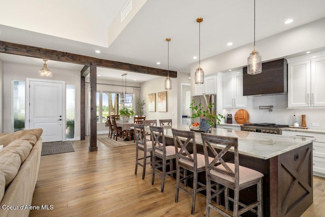1831 E Dalton Ave, Dalton Gardens, ID 83815 - kitchen with custom range hood, stainless steel refrigerator, recessed lighting, light wood-style flooring, and open floor plan