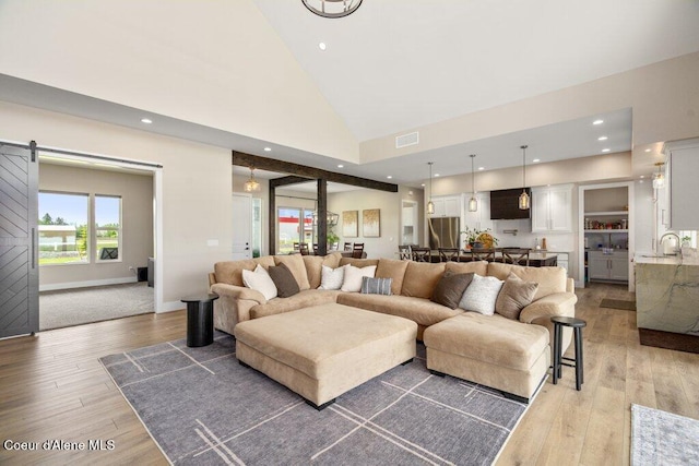 1831 E Dalton Ave, Dalton Gardens, ID 83815 - living room with high vaulted ceiling, light wood finished floors, baseboards, recessed lighting, and a barn door