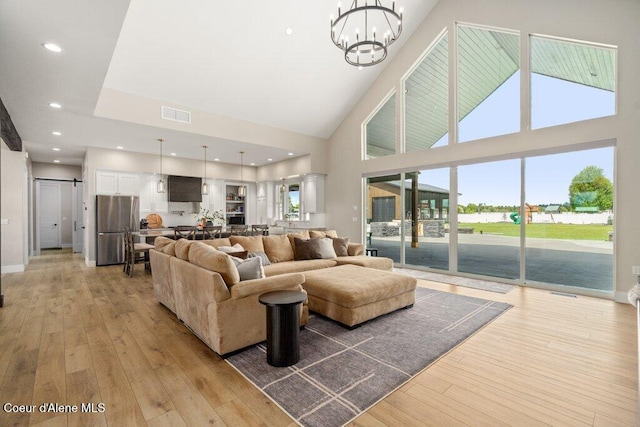 1831 E Dalton Ave, Dalton Gardens, ID 83815 - living area featuring a high ceiling, light wood finished floors, a chandelier, baseboards, and recessed lighting