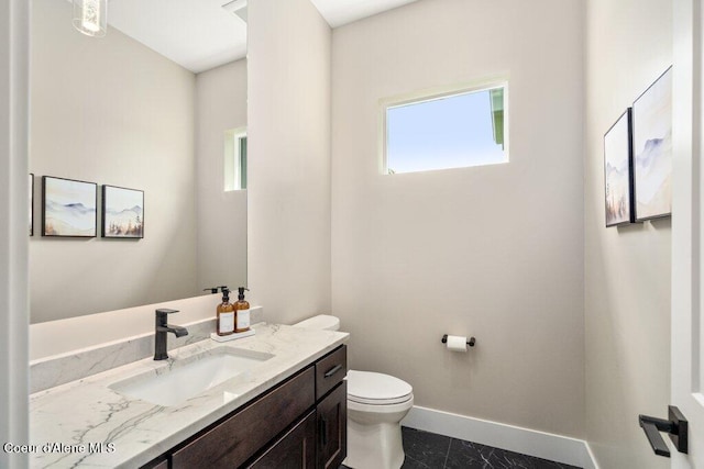 1831 E Dalton Ave, Dalton Gardens, ID 83815 - bathroom with baseboards, toilet, and vanity
