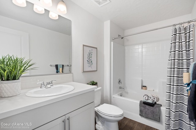 13659 N Apex Way, Hayden, ID 83835 - bathroom with tasteful backsplash, vanity, toilet, wood finished floors, and shower / bath combo